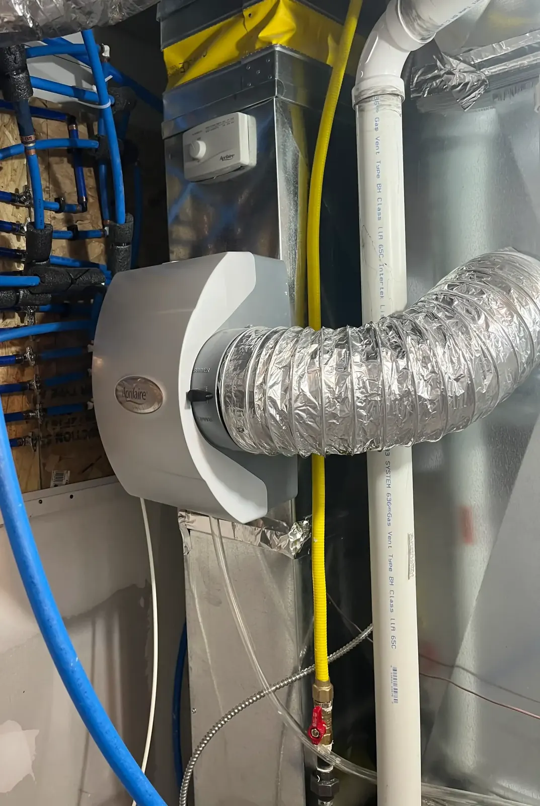 Ductwork, humidifier, and piping installed in residential basement