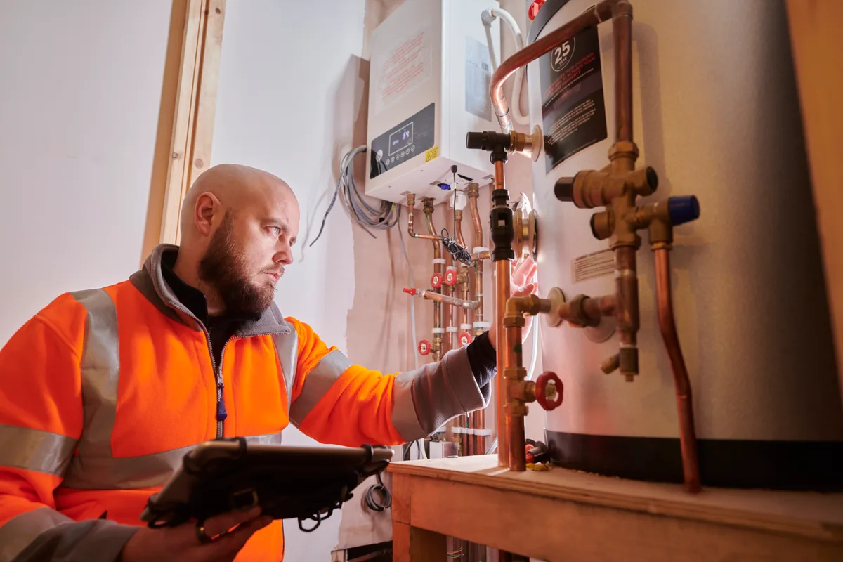 Heating engineer installing a heating system