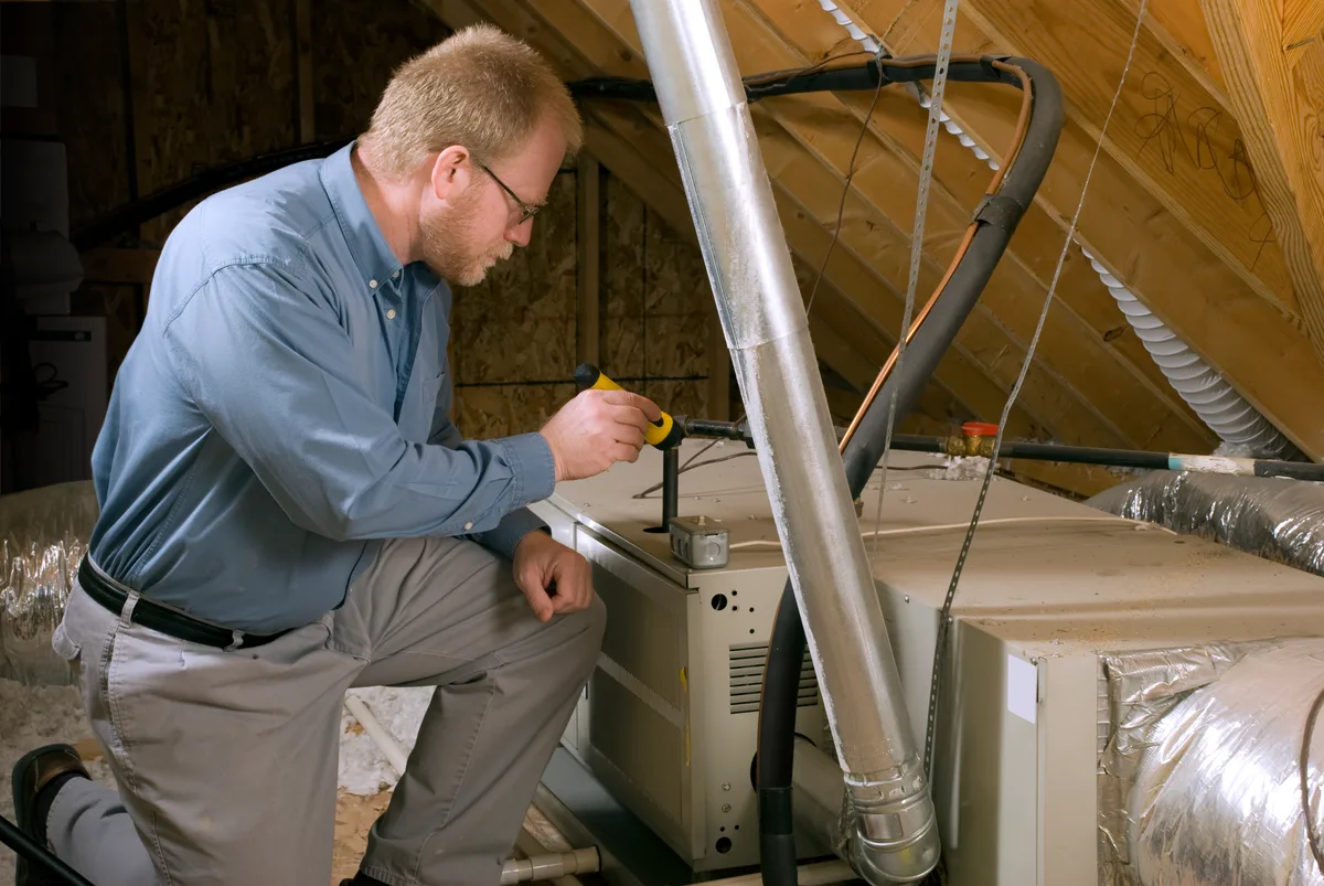 Service technician inspecting a gas furnace