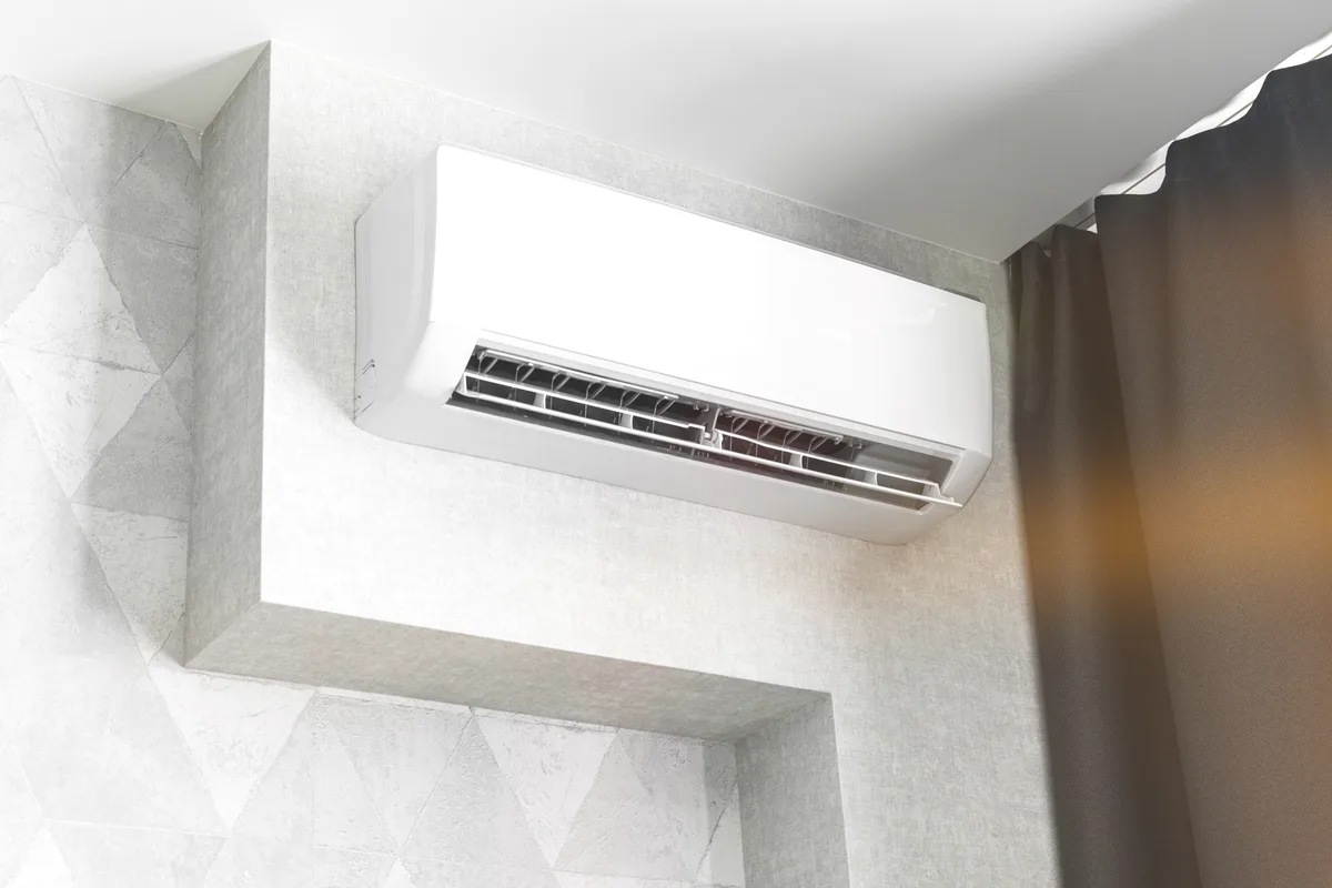 Wall-mounted air conditioner head in a living room